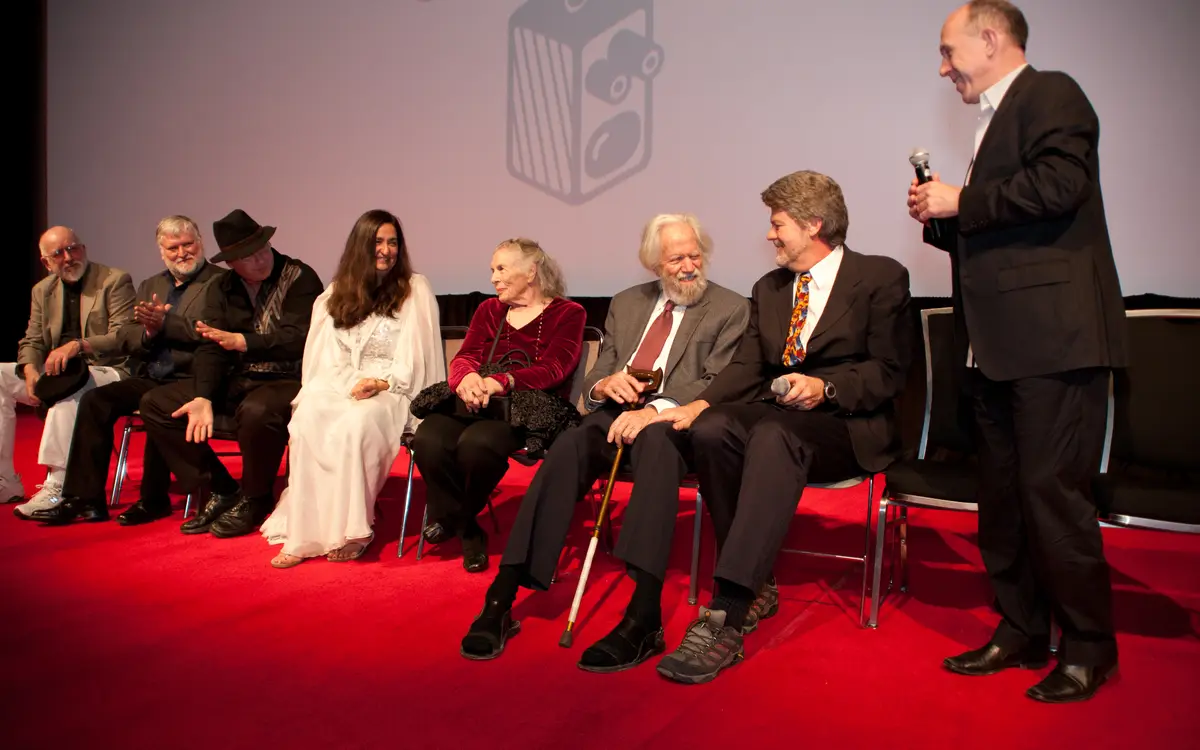Ann and Alexander Shulgin seated on stage among a panel of guests at a documentary screening event