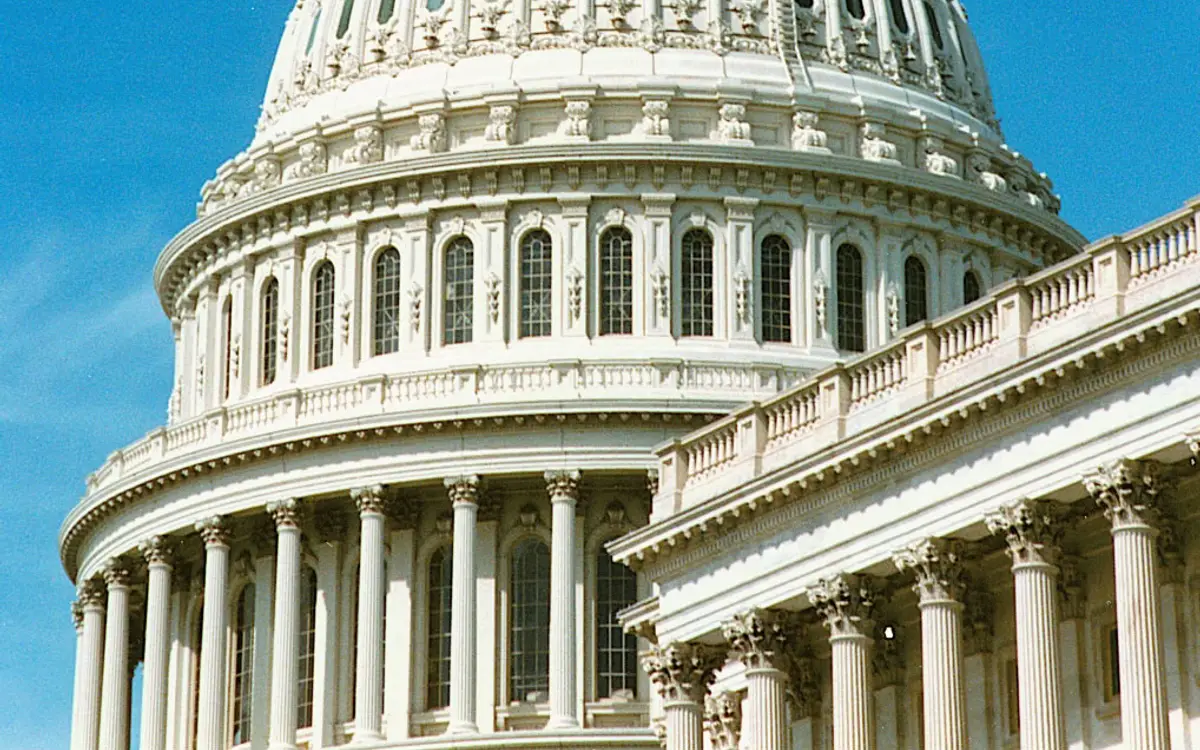 The dome of the United States Capitol building against a blue sky